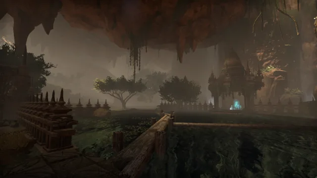 Meditative Garden with a wooden walkway over the water and a shrine under the cave ceiling